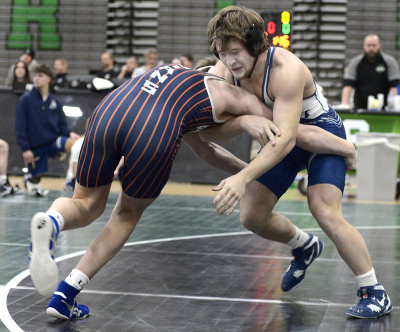 Marquette’s Reily Leifheit works to bring down Pontiac’s Luke Maier in the 175# match Wednesday at Seneca.