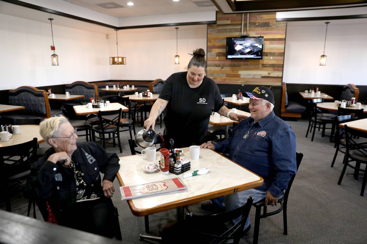 Ashley Medows pours coffee for Lori Michelson and Roger Treend of Bristol at Yolkville, the former Silver Dollars Restaurant at 102. E. Stagecoach Trail in Yorkville