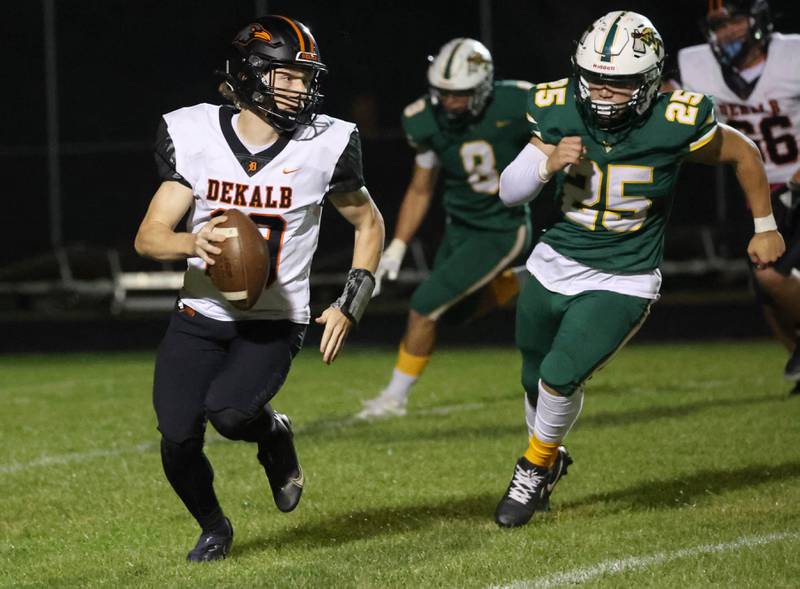 DeKalb's Michael Hodge is chased out of the pocket by Waubonsie Valley’s Will Tracy during their game Friday, Oct. 11, 2024, at Waubonsie Valley High School in Aurora.
