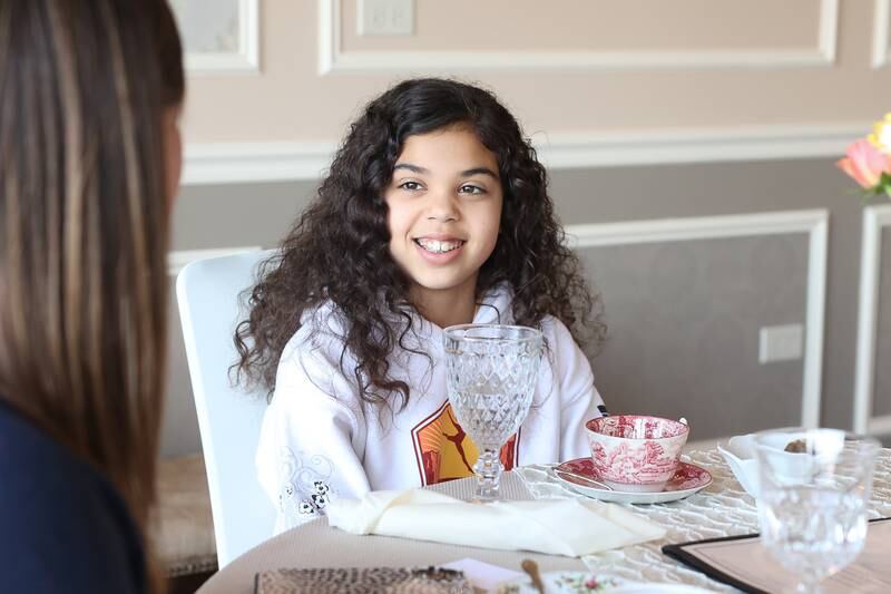 Avery Moore, 11, enjoys tea with her mother and sister at the Royal Tea Room on Friday, March 29, 2024 in Shorewood.