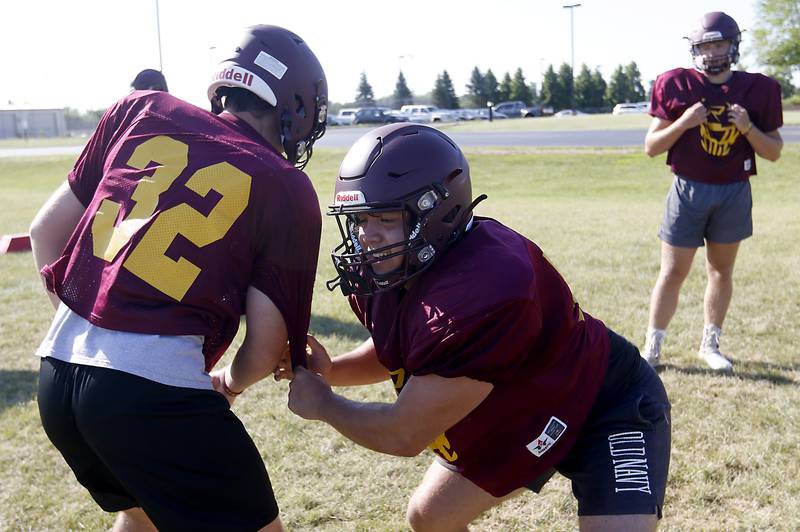 Richmond-Burton’s Jacob Gray, right, grabs Steven Segel’s jersey during a blocking drill during summer football practice Thursday, July 14, 2022, at Richmond-Burton High School in Richmond.