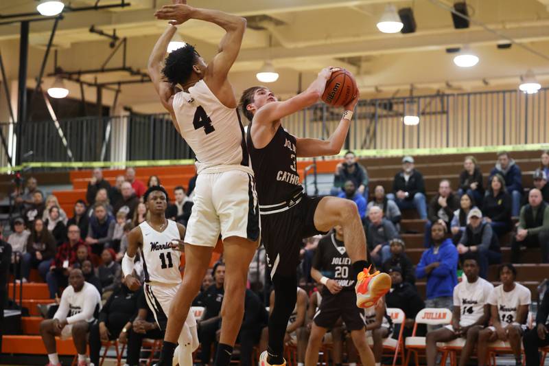 Joliet Catholic’s Tyler Surin goes in for the basket against Prespectives in the Class 2A Julian Sectional championship on Friday, March 3rd, 2023 in Chicago.
