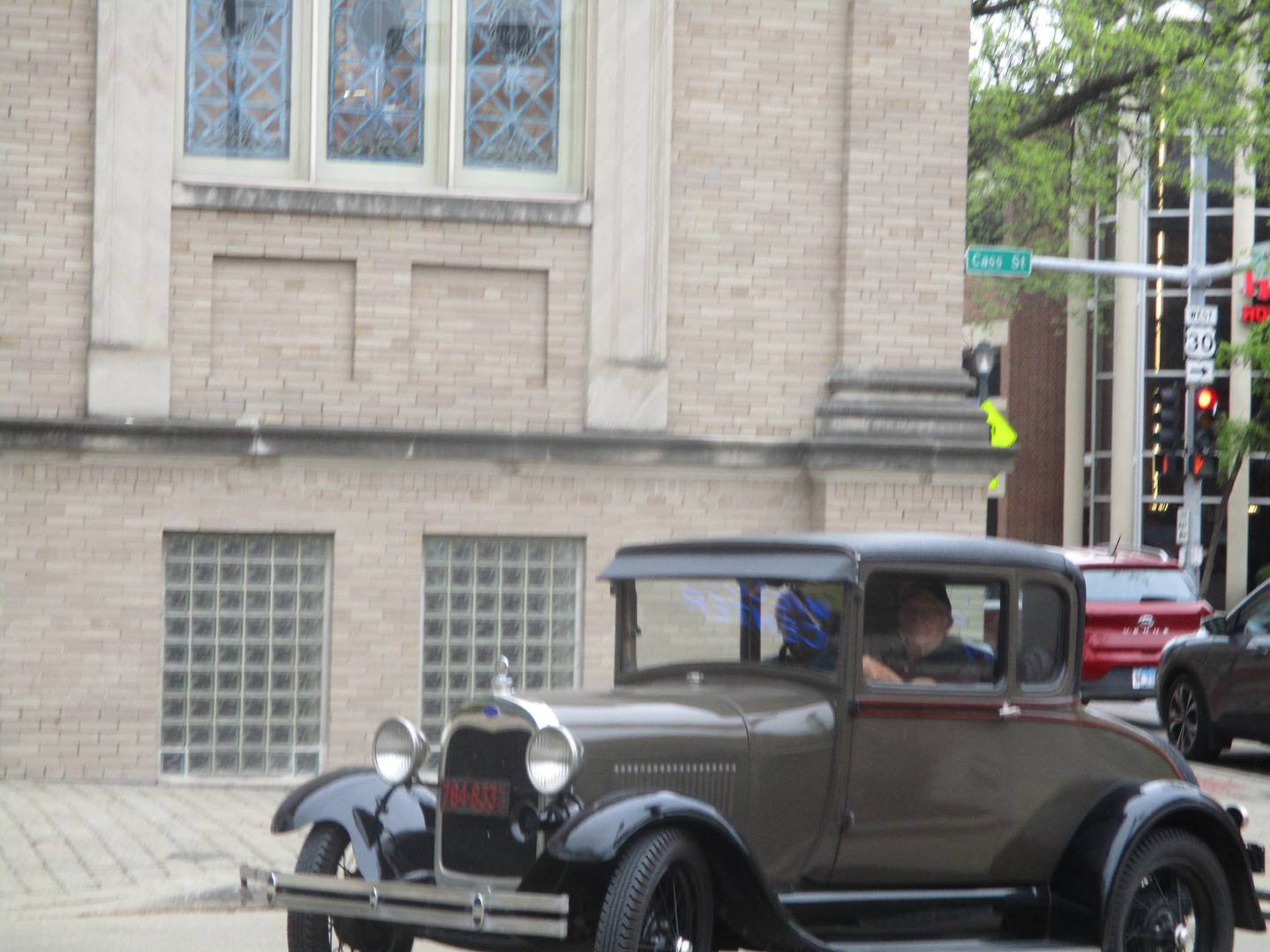 A vintage car cruises around the driveway of the Joliet Area Historical Museum on Saturday, May 6, 2023.