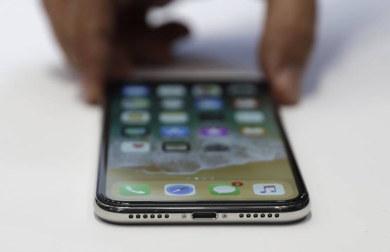 The new iPhone X is displayed in the showroom after the new product announcement at the Steve Jobs Theater on the new Apple campus on Tuesday, Sept. 12, 2017, in Cupertino, Calif.