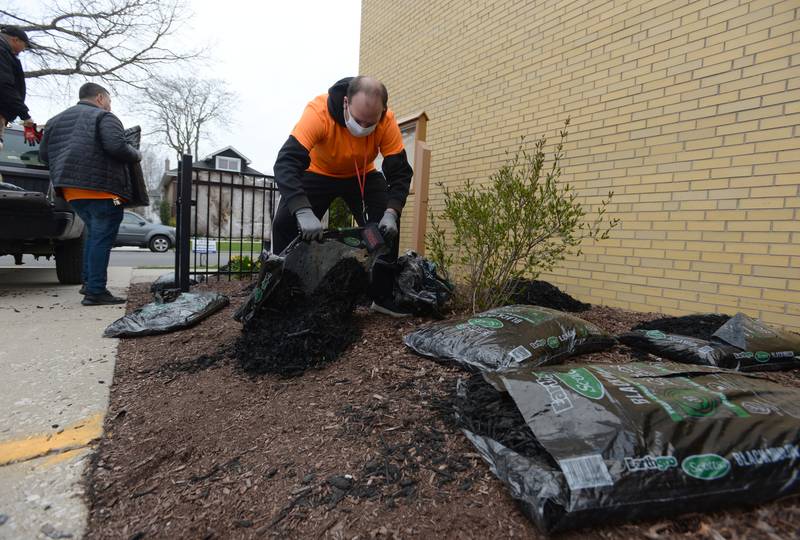 Heritage Middle School Teacher Assistant Mark Polak helps spread mulch provided by Home Depot  during the Beautification day held in collaboration with the school's OAV Club and Instructional Special Ed Science class Wednesday April 20, 2022.