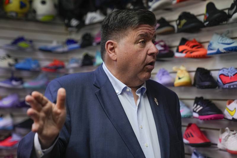 Illinois Gov. J.B. Pritzker visits with members of the family-owned soccer gear business Extreme Soccer, Thursday, Sept. 4, 2025, in Berwyn, Ill. (AP Photo/Erin Hooley)