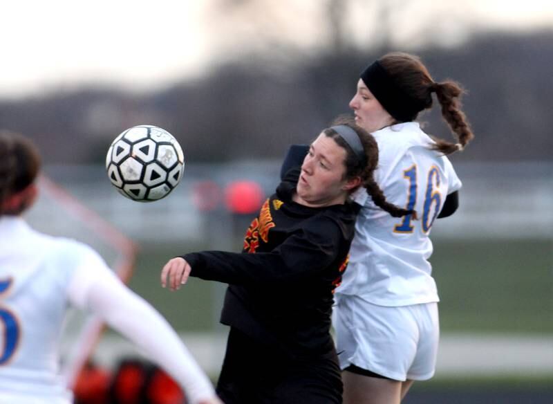 Batavia’s Mia Anzalone (23) and Wheaton North’s Macy Hutchinson (16) go after the ball during a game at Batavia on Thursday, April 7, 2022.