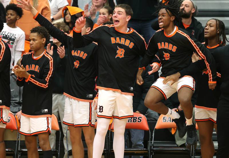 The DeKalb bench celebrates as the time expires in their win over Waubonsie Valley Friday, Feb. 21, 2025, at DeKalb High School.