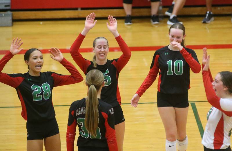 Members of the L-P volleyball team celebrate after defeating Geneseo in the Class 3A Regional on Tuesday, Oct. 24, 2023 at Sellett Gymnasium.