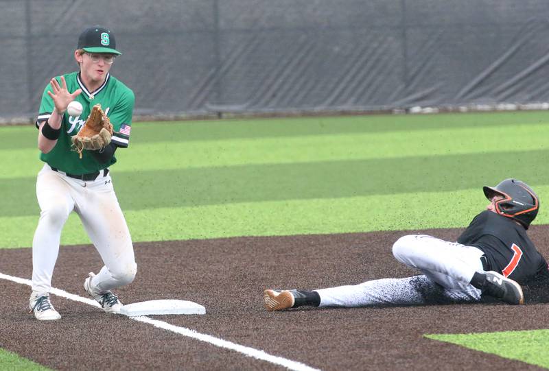 Seneca's Brody Rademacher secures a throw to third base as Roanoke-Benson/Lowpoint Washburn's JT Beer steals the bag on Thursday, May 1, 2025 at Seneca High School.