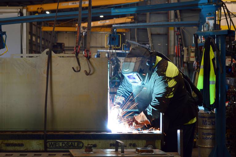 An employee of Astec Mobile Screens, of Sterling, welds a piece of equipment the company produces on Tuesday, Oct. 1, 2024.