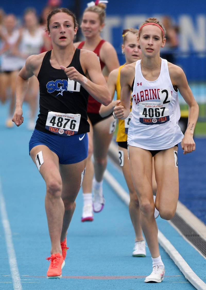 St. Charles North's Kara Glenn, left, overtakes Barrington's Mia Sirois on the bell lap of the 1,600-meter run during the Class 3A girls track and field state meet at Eastern Illinois University on Saturday, May 23, 2026 in Charleston.
