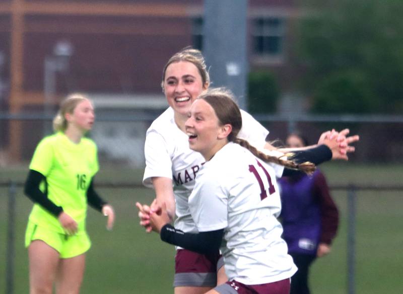 Marengo’s Kiley Brady, back, celebrates an OT goal by Mackenzie Westwood, front, against Richmond-Burton in IHSA Class 1A Regional Title Game action soccer at Marengo High School in Marengo on Wednesday, May 21, 2025.