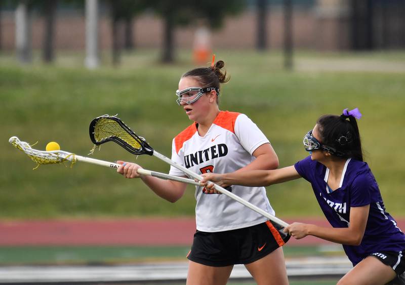 Crystal Lake’s Lyla Meyers juggles the ball as Downers Grove North’s Ella Cho (right) reaches to knock it loose during the Benet Supersectional game on June 3, 2025 at College of DuPage in Glen Ellyn.