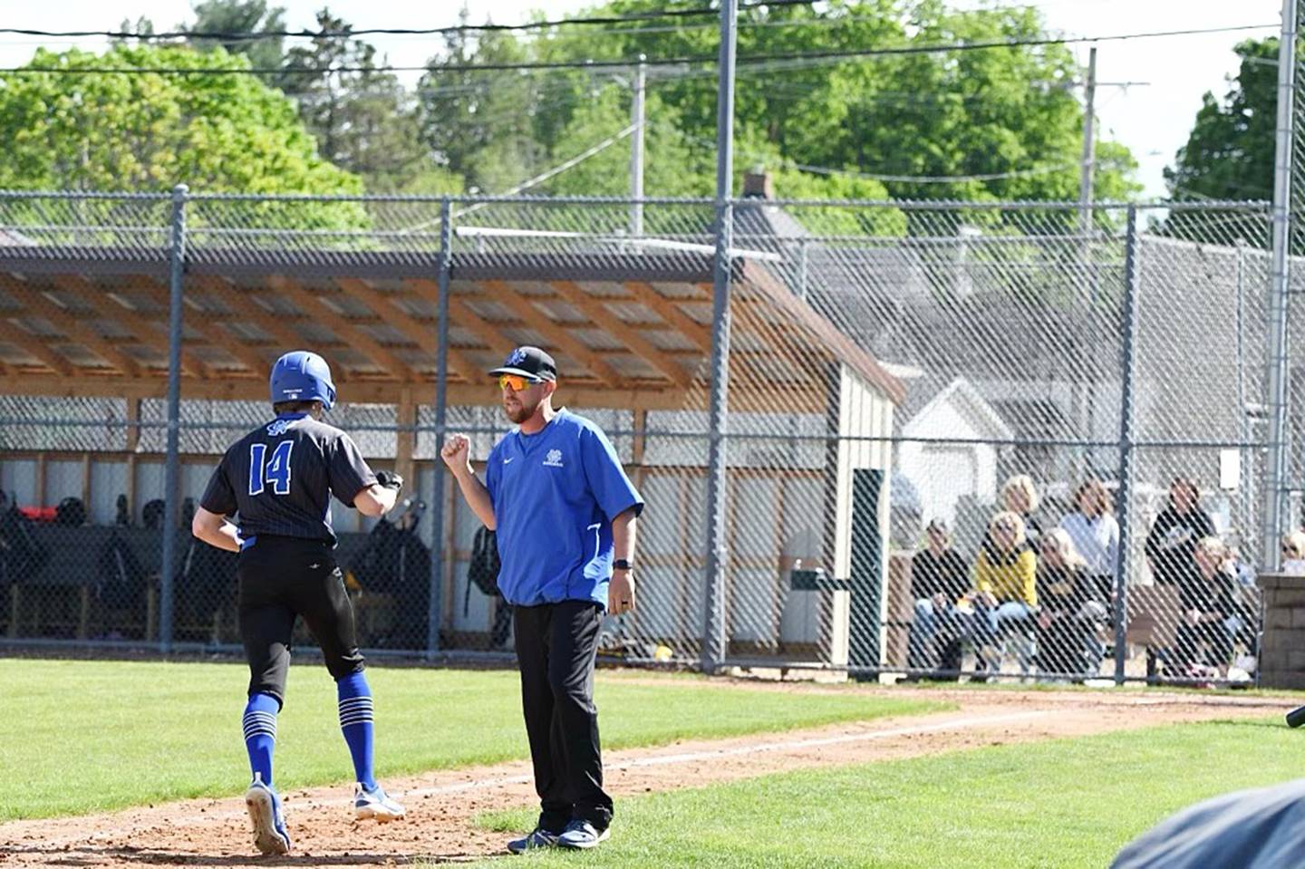 Newman coach Kenny Koerner (right) congratulates Kory Mullen after his home run in the 1A Lena-Winslow Sectional semifinal on May 27 in Lena.