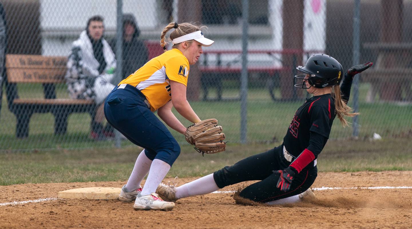 Yorkville's Kaitlyn Roberts (8) beats the throw slides into third base against Neuqua Valley's Izzy Ernest (13) during a softball game at Yorkville High School on Wednesday, April 6, 2022.