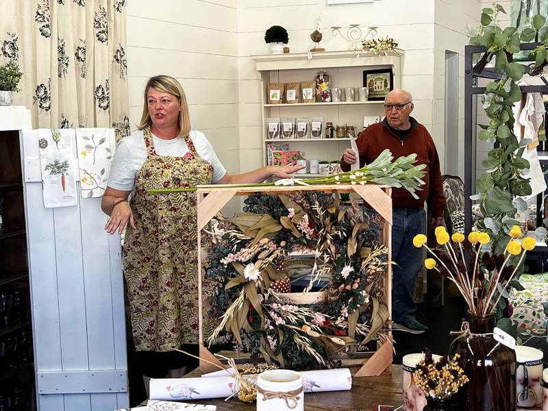 Owner Letha Catalina of Dixon and volunteer David Nelson of Grand Detour set up floral arrangements at Chickweed Cottage's new Dixon location.