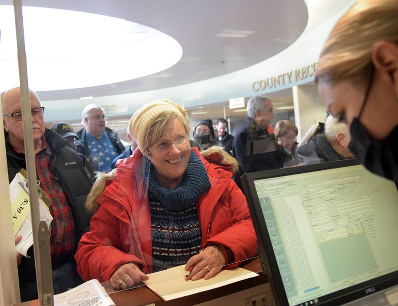 Director of Elections Raymond Esquivel, right, instructs candidates that they can come in out of the snow during the first day of candidate filing at the Kane County Clerk’s office Monday, March 7, 2022 in Geneva.