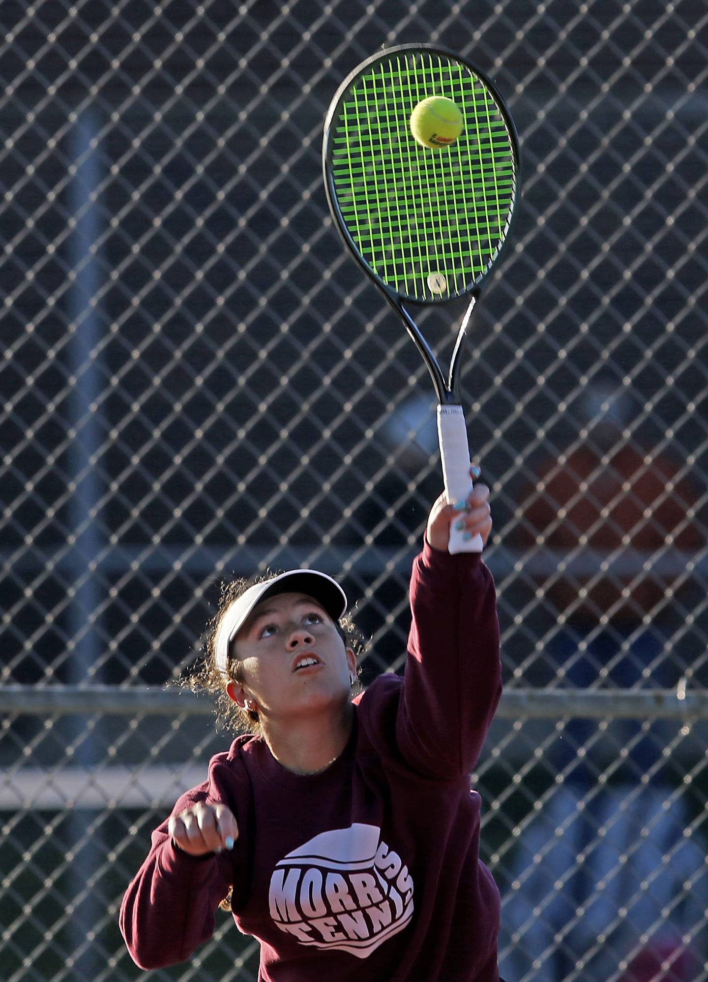 Morris' Skyler Saelens serves the ball Thursday, Oct. 23, 2025, during the first day of the IHSA State Girls Tennis Tournament at Schaumburg High School.
