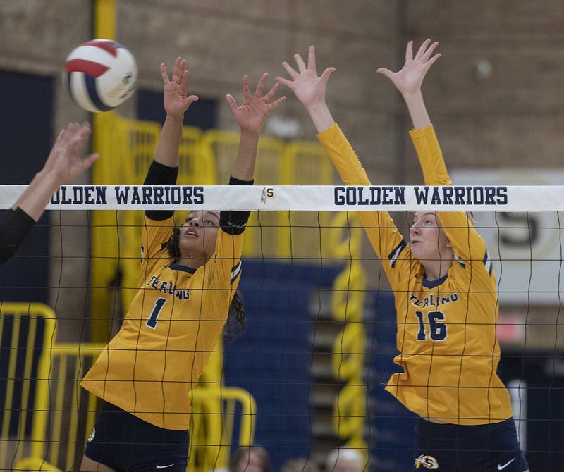 Sterling’s Nia Harris (left) and Kasey Weeks go up for a block against Alleman Tuesday, Oct. 22, 2024, in Sterling.