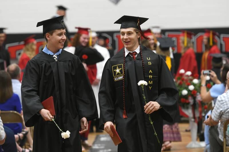 Ryan Morris (right) and ???? exit the Forreston High School gym following commencement on Sunday. Fifty-five seniors received diplomas during the afternoon event. Morris will be entering the U.S. Army.