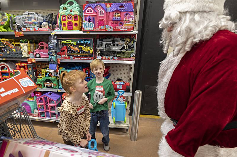 Aubrey, 6, and Owen Wilhite, 7, speak with Santa Saturday, Dec. 9, 2023. Dixon police treated 66 kids to Christmas shopping as part of the their Shop with a Cop program.
