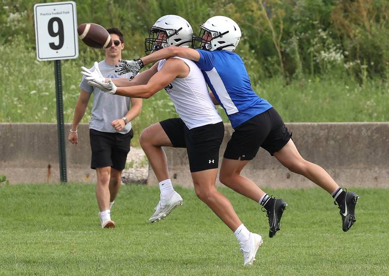 Kaneland’s Dylan Sanagustin catches a pass in front of a Geneva defender Tuesday, July 16, 2024, during their matchup in the Kaneland 7-on-7 at the school in Maple Park.