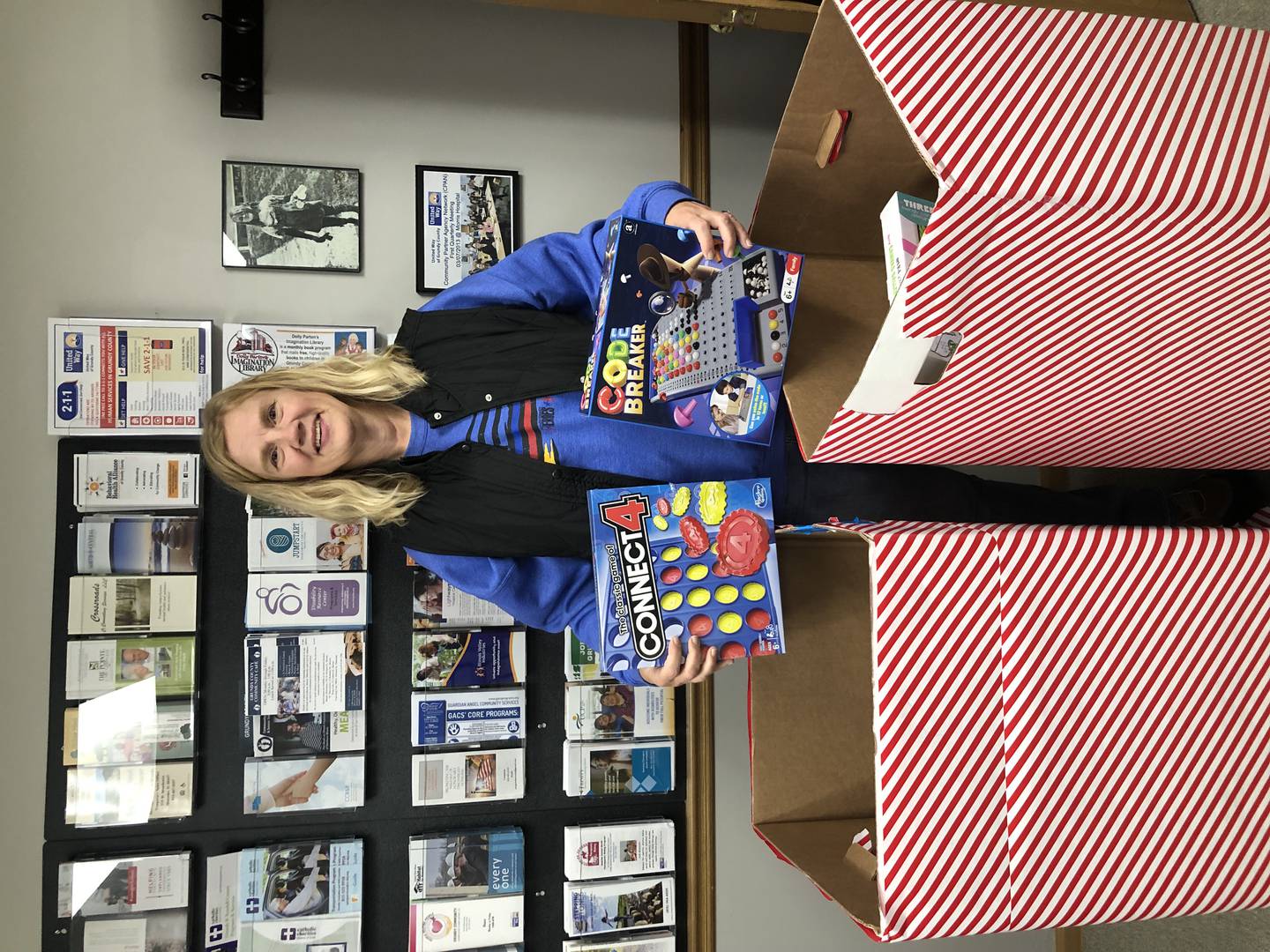 Heroes & Helpers volunteers prepare toys donated during the annual toy drive for distribution to local families.