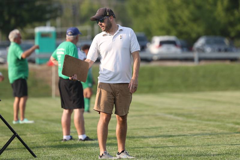 Joliet Catholic head coach Tom Cranmer talks to the players on the bench during a match against Providence on Aug. 21, 2023 in New Lenox.