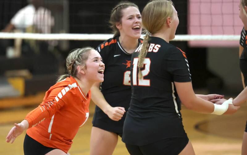 DeKalb players celebrate a point during their match Monday, Oct. 16, 2023, at Sycamore High School.
