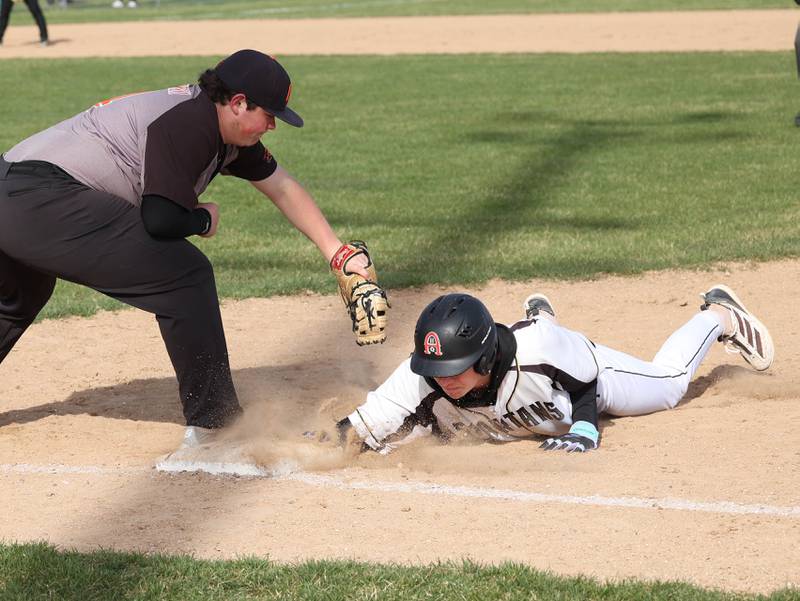Sycamore's Chace Kuhns dives back safely into first as Freeport's Chace Krzeminski applies the tag Tuesday, April 7, 2026, during their game at the Sycamore Community Sports Complex.