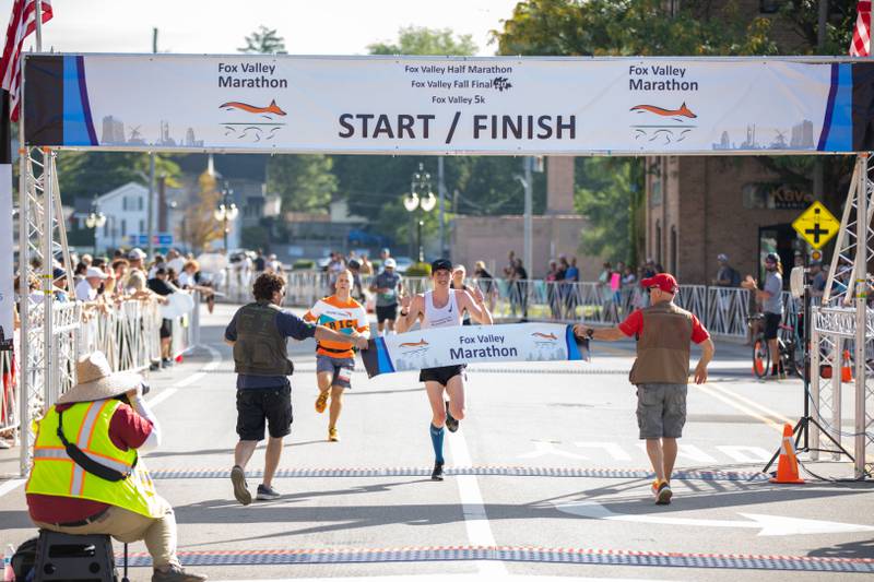 Nolan McKenna crosses the finish line at the Fox Valley Marathon on Sunday, Sept. 18, 2022. McKenna finished as the first  male finisher in the marathon.