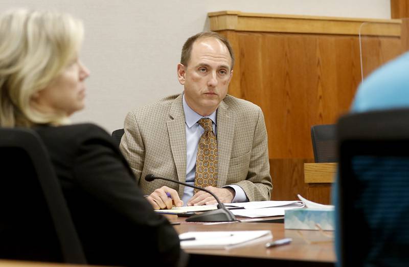 McHenry County Chief Judge Michael Chmiel listens to discussion during a meeting with McHenry County Judge Tiffamy Davis, the presiding judge of the criminal division; Dan Wallis, the trial court administrator and Seth Krause, the director of McHenry County Probation and Court Services, to discuss how they are going to implement the SAFE-T Act on Tuesday, July 18, 2023.