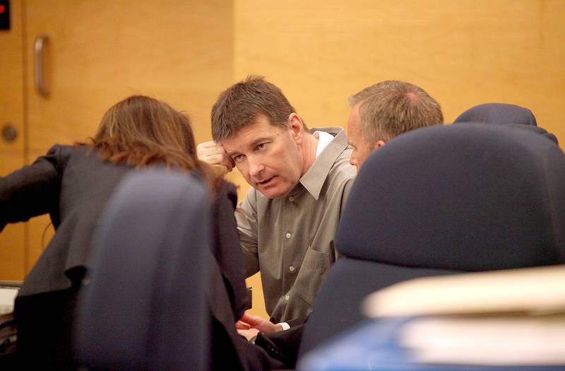 Shadwick King (center) speaks with his attorneys, Kane County Public Defender Kelli Childress (left) and Dan Konicek, special public defender, on Friday during his trial at the at the Kane County Judicial Center in St. Charles Township.
