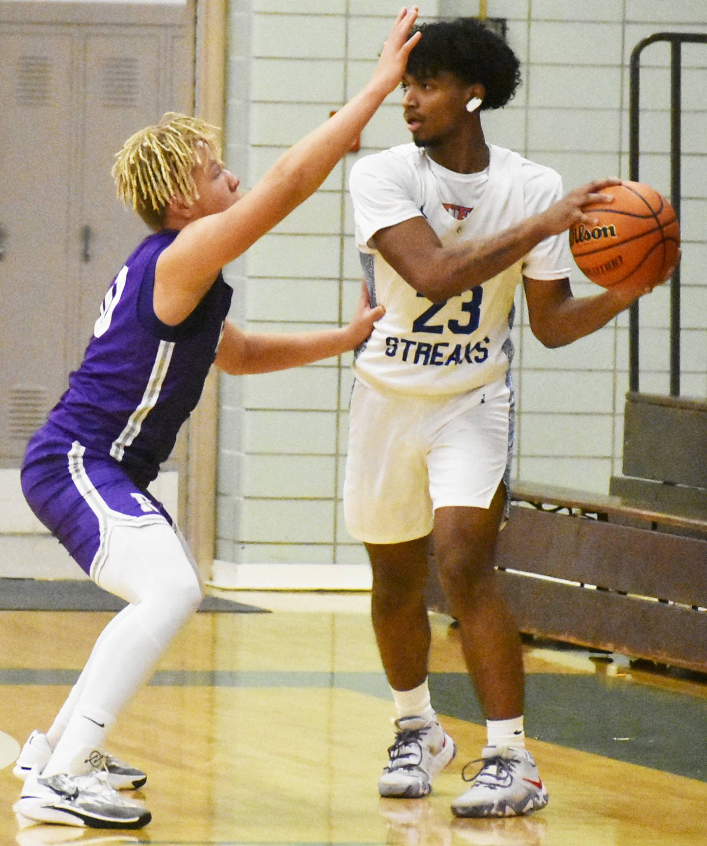 Woodstock’s Anthony Grzetic (23) avoids the outstretched hand of Rochelle’s Elijah Harley during Wednesday’s 3A regional semifinal at Rockford Boylan.