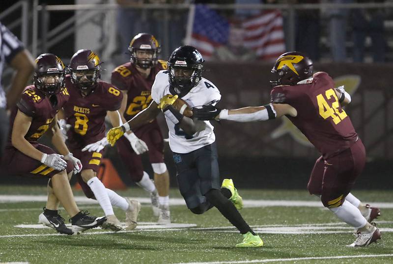 Woodstock North's Sean Mitchell tries to avoid Richmond-Burton's Blake Livdahl as he runs after catching the ball during a Kishwaukee River Conference football game on Friday, Oct. 11, 2024, at Richmond-Burton High School.