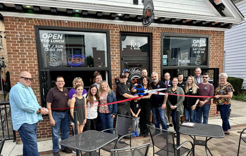 Jose Moreno, owner of Bella’s Wood Fire Pizzeria in Algonquin, along with co-owners, Brittany and Tony Colatori, cuts the ribbon celebrating the opening of the restaurant.  They are joined by family, friends, staff, and the staff and members of the Cary-Grove Area Chamber of Commerce.