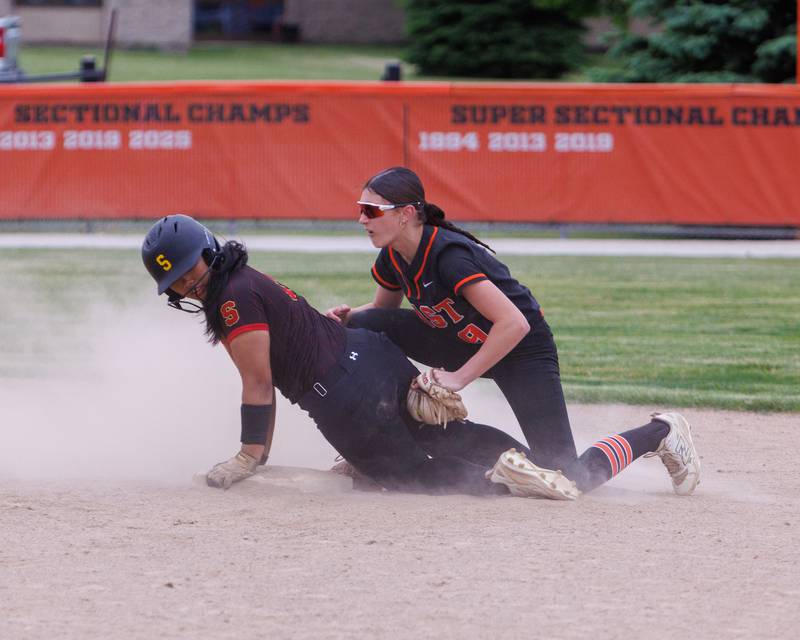 Schaumburg's Francheska Manding slides into second base before the tag by st. Charles east's Ari Bigda at the Class 4A St. Charles East Regional Final on Friday, May 22,2026 in St. Charles.