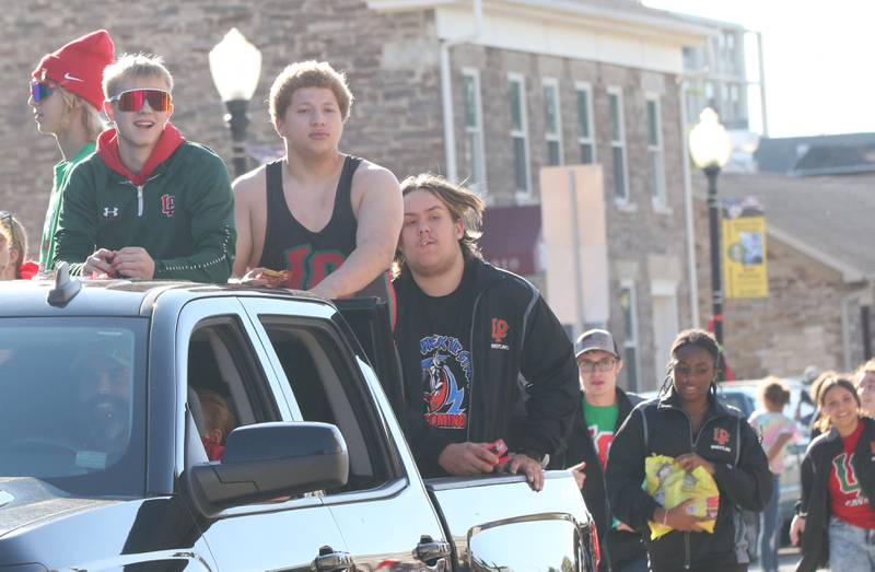 Members of the L-P Wrestling team and the L-P Gay-Straight Alliance club ride in the Homecoming parade on Thursday, Oct. 5, 2023 downtown Peru.