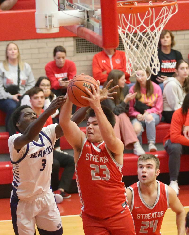 Streator's Logan Aukland grabs a rebound over Plano's Christ Keleba during the Dean Riley Shootin' The Rock Thanksgiving Tournament on Monday, Nov. 20, 2023 at Kingman Gym.