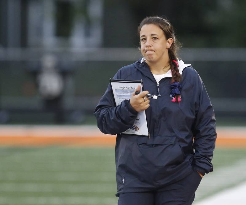 Cary-Grove Head Coach Grace Lauren Kasala walks th sidelines during an IHSA McHenry Sectional semifinal girls flag football game against Harlem on Monday, Oct. 13, 2025, at McCracken Field in McHenry.