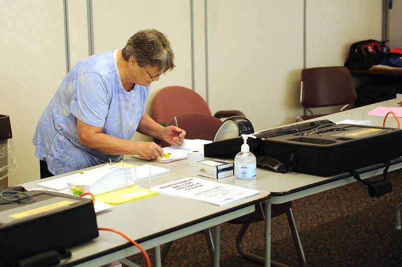 Election Judge Peg Stock prepares to open the polling location Friday, June 24, 2022, at the McHenry County Administration Building, 667 Ware Road in Woodstock. Polls are open from 6 a.m until 7 p.m. today for people to cast their ballot in the in the primary election.
