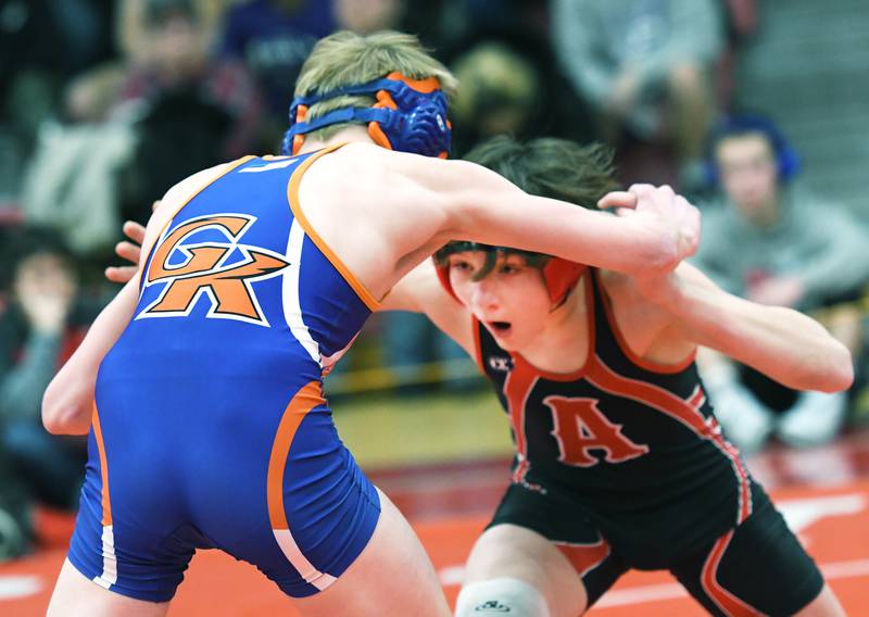 Amboy's Landon Blanton (right) dives in on Genoa-Kingston's Shayden McNew during their 113-pound match at the 1A Oregon Wrestling Sectional on Friday night.