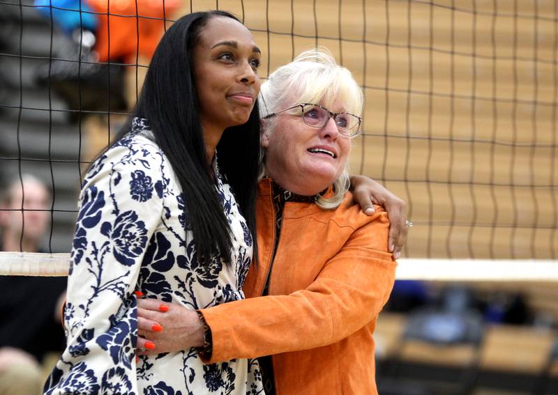 St. Charles East head girls volleyball coach Jennie Kull (right) embraces St. Charles North head coach Lindsey Hawkins during a tribute in honor of Kull’s final season at St. Charles North on Tuesday, Oct. 4, 2022.