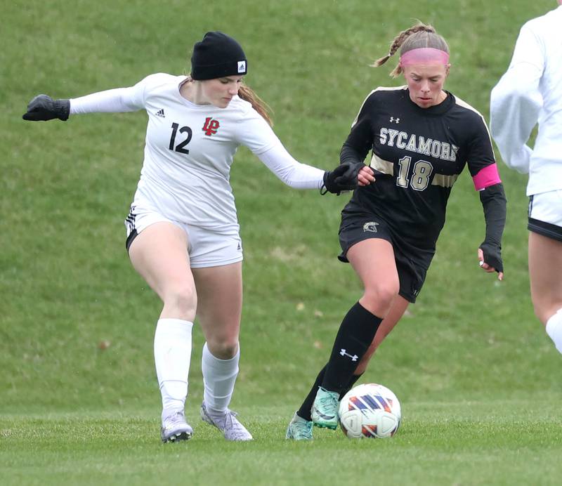 La Salle-Peru's Avalyn Edwall tries to get the ball from Sycamore's Taylor Zemanek during their game Wednesday, April 9, 2025, at Sycamore High School.