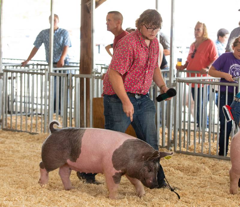 Jesse Armbrust of Hebron shows his pig during the 75th Anniversary of the McHenry County Fair in Woodstock on Thursday, August 3, 2023.