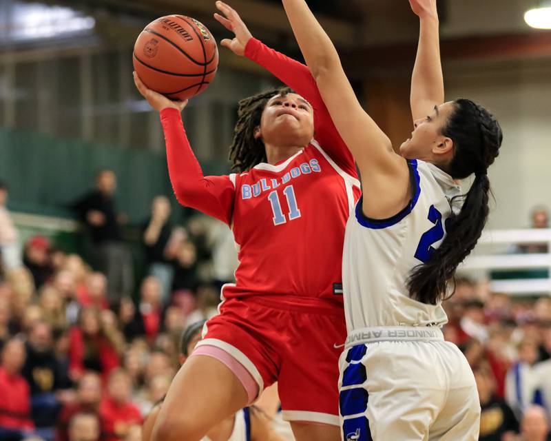 Batavia's Addison Prewitt (11) puts up a shot during Class 4A Glenbard West Sectional final game between Geneva at Batavia.  Feb 23, 2023.