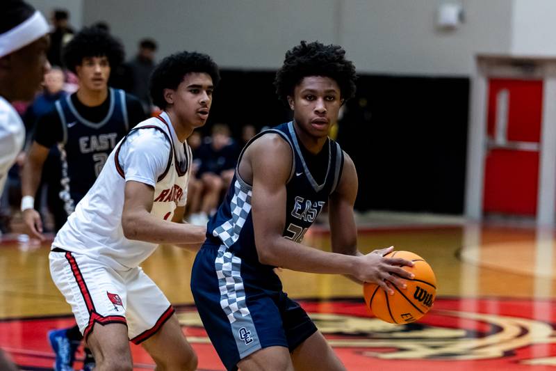 Oswego East's Dshaun Bolden makes a move during a varsity boys basketball game against Bolingbrook at Bolingbrook on Dec. 12, 2025.
