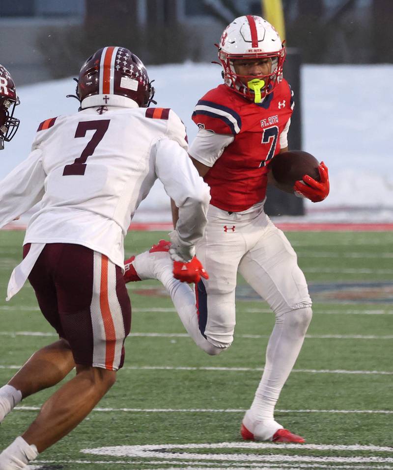 St. Rita's Donovan Evans looks to get by Brother Rice's Emeir White Wednesday, Dec. 3, 2025, during their IHSA Class 7A state chamionship game in Huskie Stadium at Northern Illinois University in DeKalb.