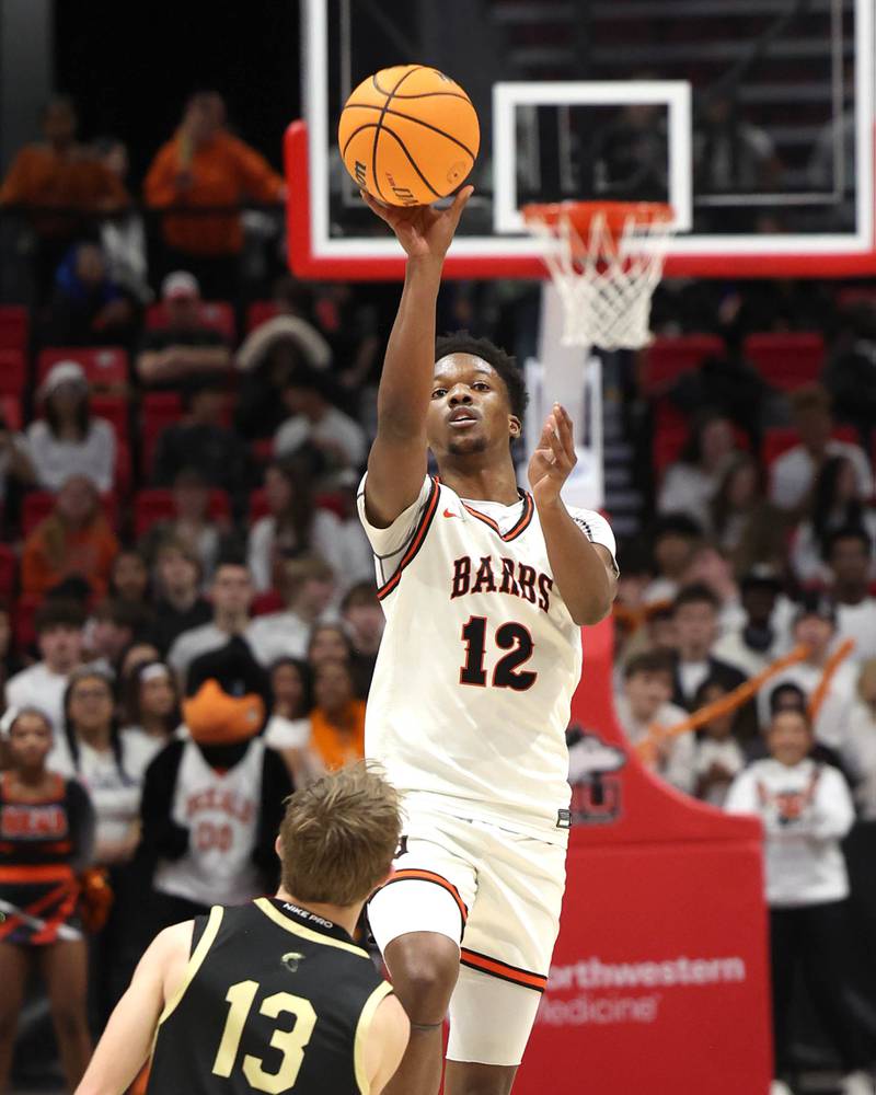 DeKalb's Derrion Straughter launches a half-court shot at the halftime buzzer over Sycamore's Xander Lewis Friday, Jan. 30, 2026, during the FNBO Challenge at the Convocation Center at Northern Illinois University in DeKalb.